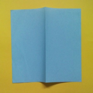 Make a mountain fold in the center as shown in the photo and make a sharp crease in the paper. Take a square piece of paper of approximate size 6 inches square. Make a mountain fold in the center as shown in the photo and make a sharp crease in the paper.