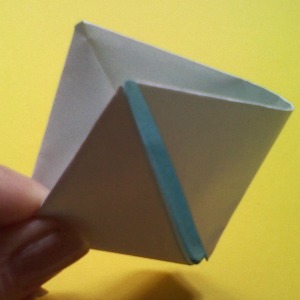 Open up the square fold by holding the outer flaps and expand to make a little Origami Boat!  If you feel confused by these directions you can watch a video: